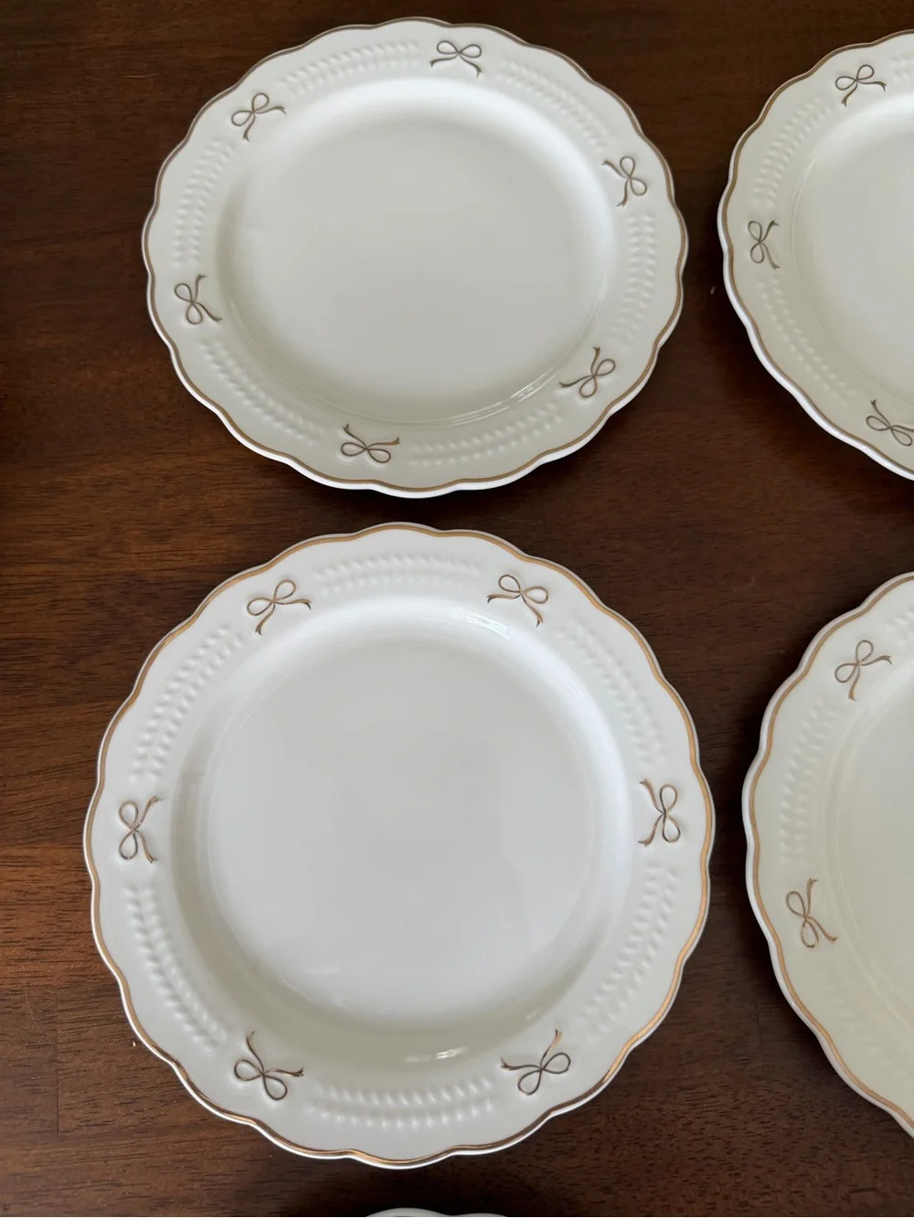 Set of White Scalloped Dinner Plates with Gold Bow Details